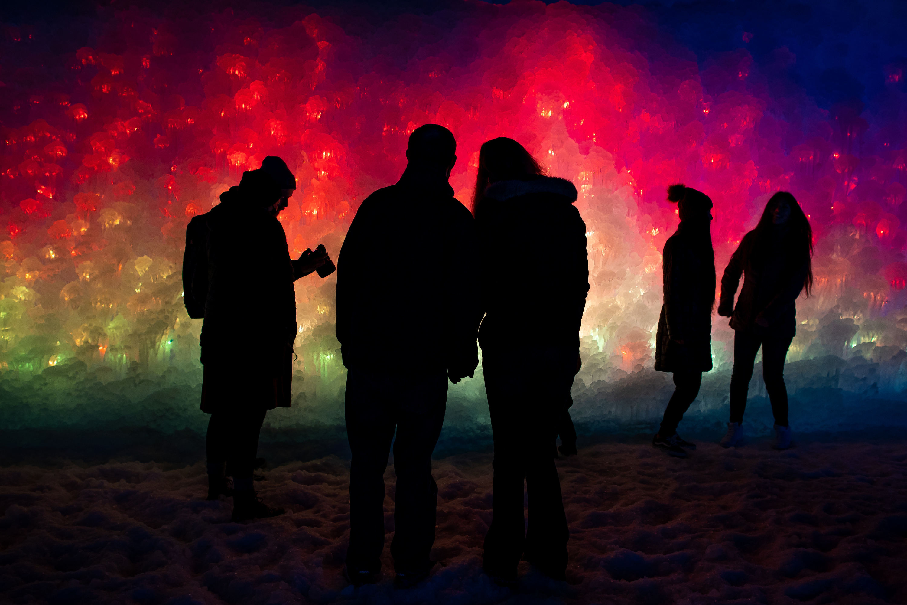 People take in colorfully illuminated ice features at the Ice Castles in Midway on Jan. 2, 2021. Ice Castles' 2025 season begins on Wednesday and will run through at least Feb. 8.