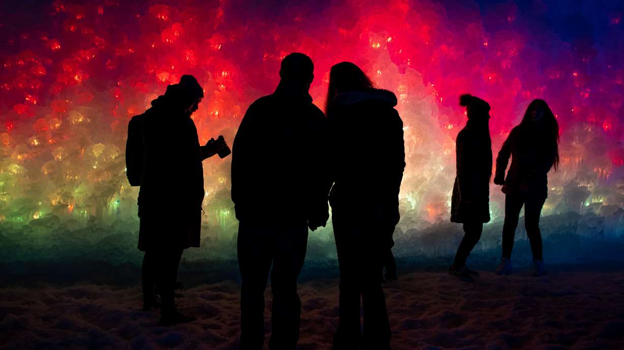 People take in colorfully illuminated ice features at the Ice Castles in Midway on Jan. 2, 2021. The winter favorite will open next week, the earliest it has ever opened, according to the company.