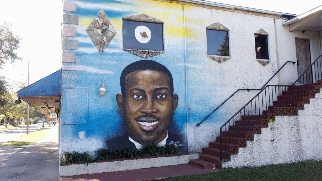 A mural of Ahmaud Arbery is painted on the side of The Brunswick African American Cultural Center in downtown Brunswick, Georgia, on Tuesday. A Georgia court struggled this week to seat jurors in the trial of three white men accused of murdering Black jogger Ahmaud Arbery.