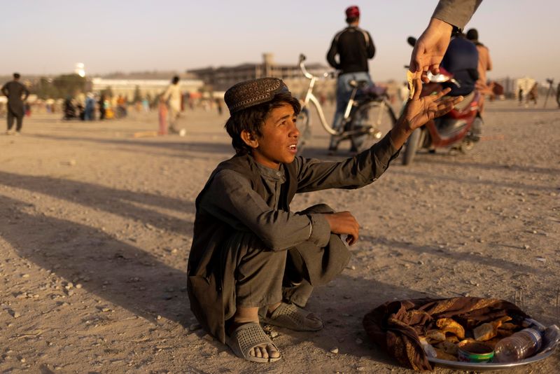 A boy sells food in a park in Kabul, Afghanistan October 22, 2021.