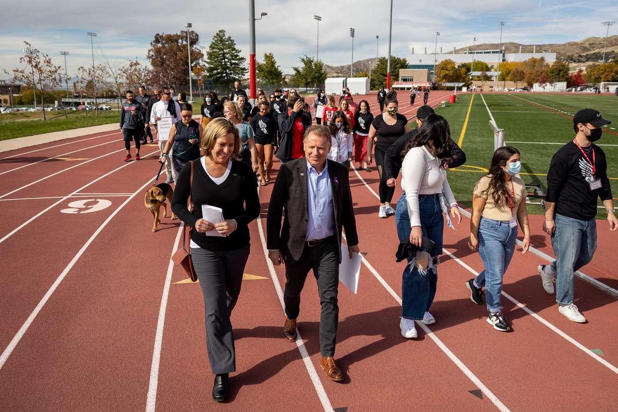 Jill McCluskey, mother of Lauren McCluskey, left, University of Utah President Taylor Randall, second from left, and others participate in a memorial walk for Lauren McCluskey at the McCarthey Family Track and Field Complex at the U. in Salt Lake City on Friday.