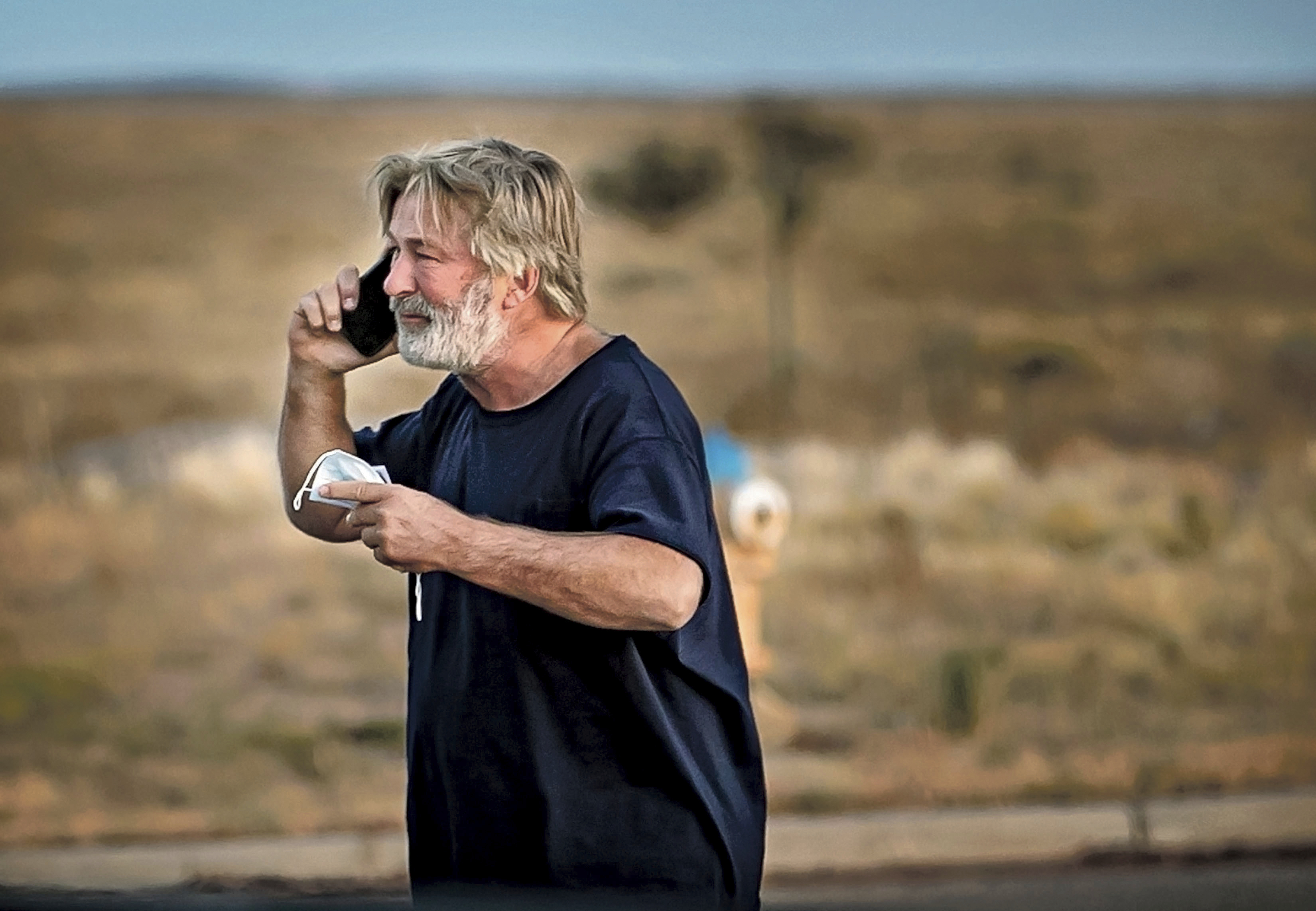 Alec Baldwin speaks on the phone in the parking lot outside the Santa Fe County Sheriff's Office in Santa Fe, N.M., after he was questioned about a shooting on the set of the film "Rust" on the outskirts of Santa Fe, Thursday. Baldwin fired a prop gun on the set, killing cinematographer Halyna Hutchins and wounding director Joel Souza, officials said.