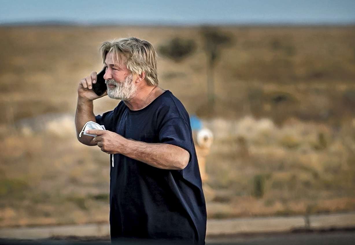 Alec Baldwin speaks on the phone in the parking lot outside the Santa Fe County Sheriff's Office in Santa Fe, N.M., after he was questioned about a shooting on the set of the film "Rust" on the outskirts of Santa Fe, Thursday.