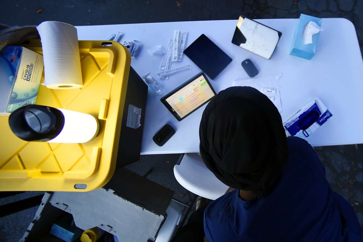 COVID19 Response representative Hadja Bah prepares for testing Oct. 22, in Marietta, Ga. When Marietta City Schools started the 2021-2022 school year, the Georgia district that serves 9,000 quickly had to quarantine about 10% of its students and staff.