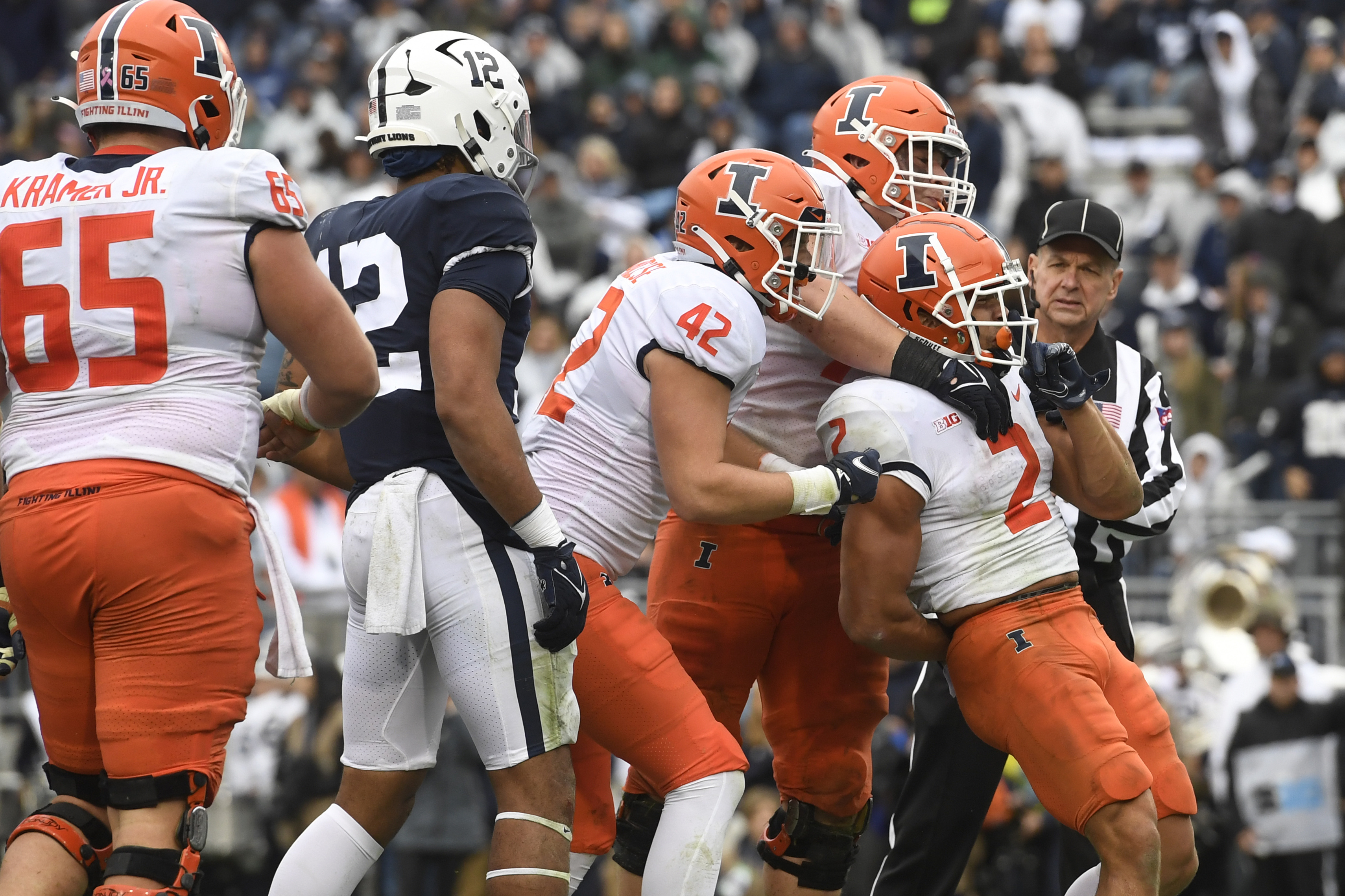 Illinois running back Chase Brown (2) celebrates with Michael Marchese (42) and Jack Badovinac after scoring on a second quarter touchdown run against Penn State during an NCAA college football game in State College, Pa., Saturday, Oct. 23, 2021.