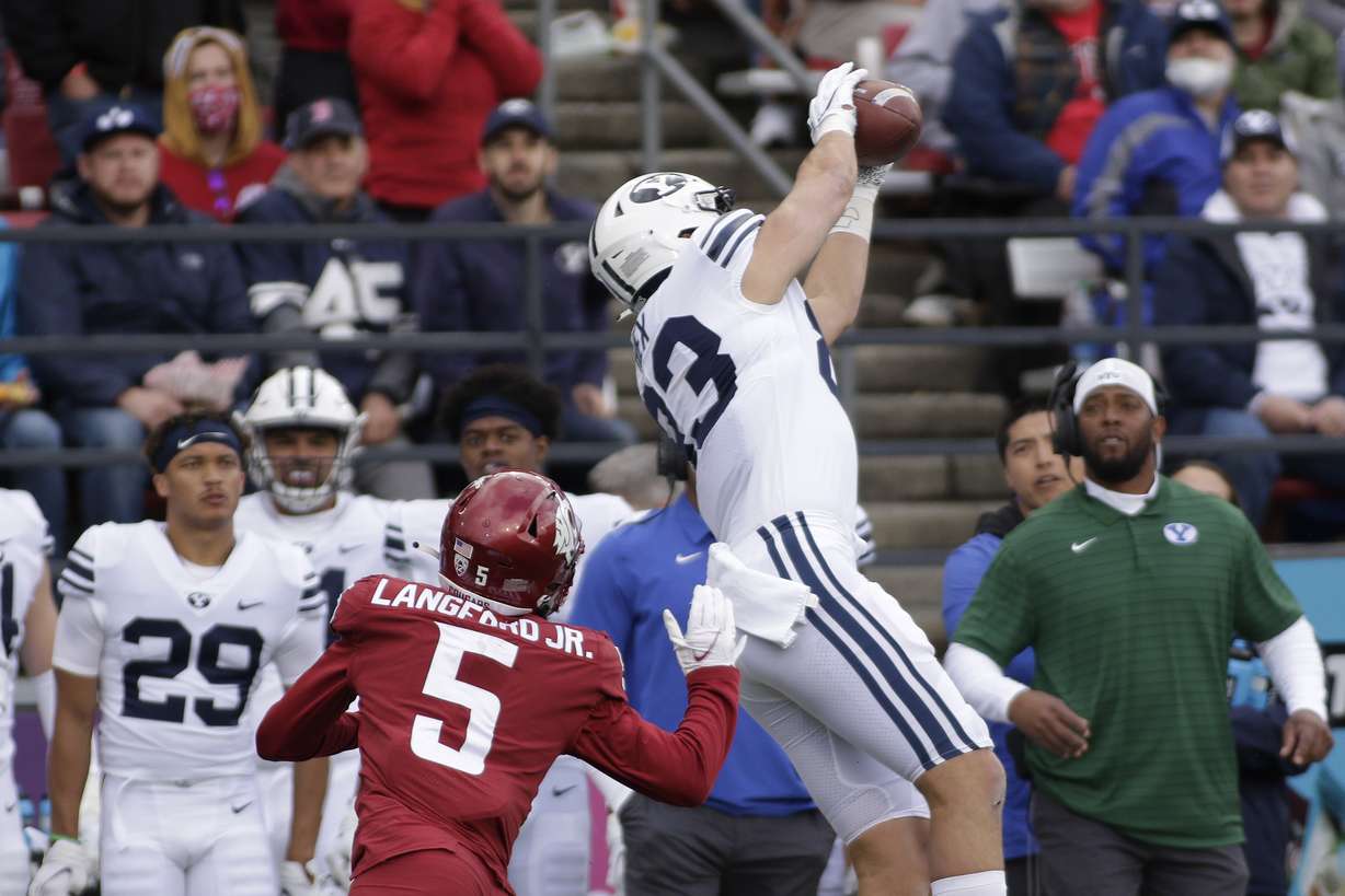 BYU tight end Isaac Rex, right, catches a pass in front of Washington State defensive back Derrick Langford during the first half of an NCAA college football game, Saturday, Oct. 23, 2021, in Pullman, Wash.