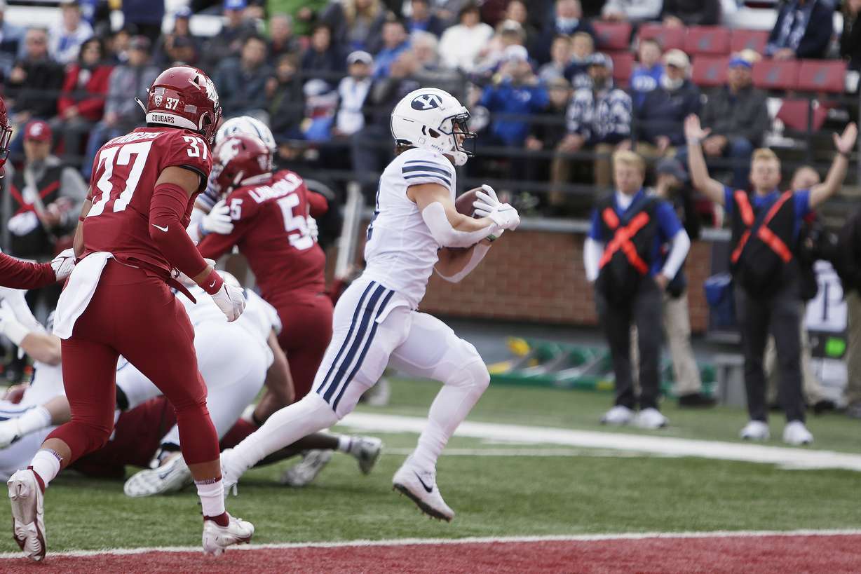 BYU running back Lopini Katoa, center, runs for a touchdown during the first half of an NCAA college football game against Washington State, Saturday, in Pullman, Wash.