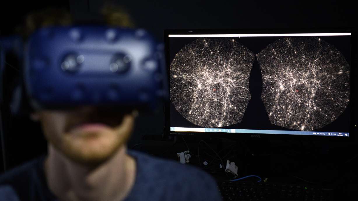 Hadrien Gurnel, software engineer at EPFL's Laboratory for Experimental Museology (eM+), explores with a virtual reality helmet the most detailed 3D map of the universe, with the virtual reality software Virtual Reality Universe Project (VIRUP) developed by the Swiss Federal Institute of Technology, in Saint-Sulpice near Lausanne, Switzerland.