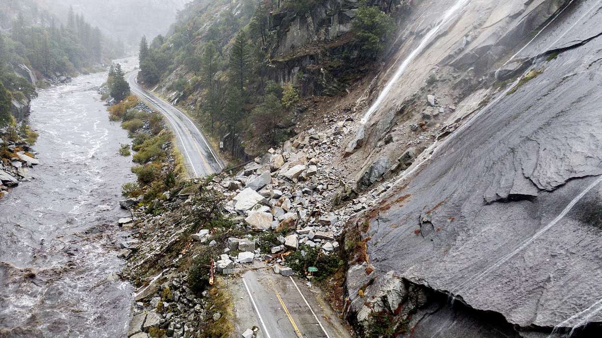 Rocks and vegetation cover Highway 70 following a landslide in the Dixie Fire zone on Sunday, in Plumas County, Calif. Heavy rains blanketing Northern California created slide and flood hazards in land scorched during last summer's wildfires.