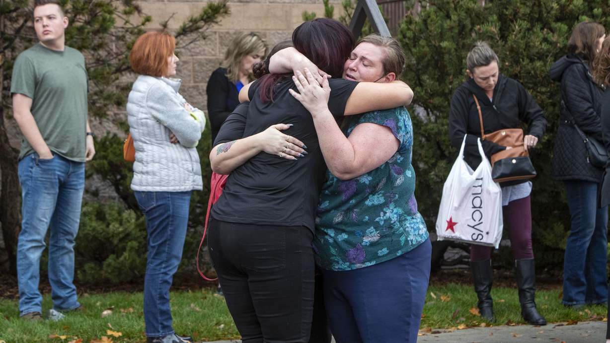 People evacuated from the Boise Towne Square shopping mall await news after a man opened fire in the mall Monday, in Boise, Idaho.