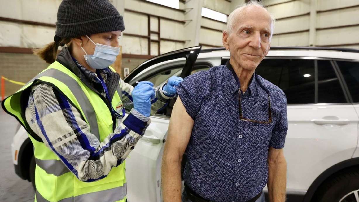 Kelsey Wetzel, a registered nurse with Davis County
Community Health, gives a COVID-19 vaccine booster shot to William
Boren, Monday at the Davis Legacy Center.