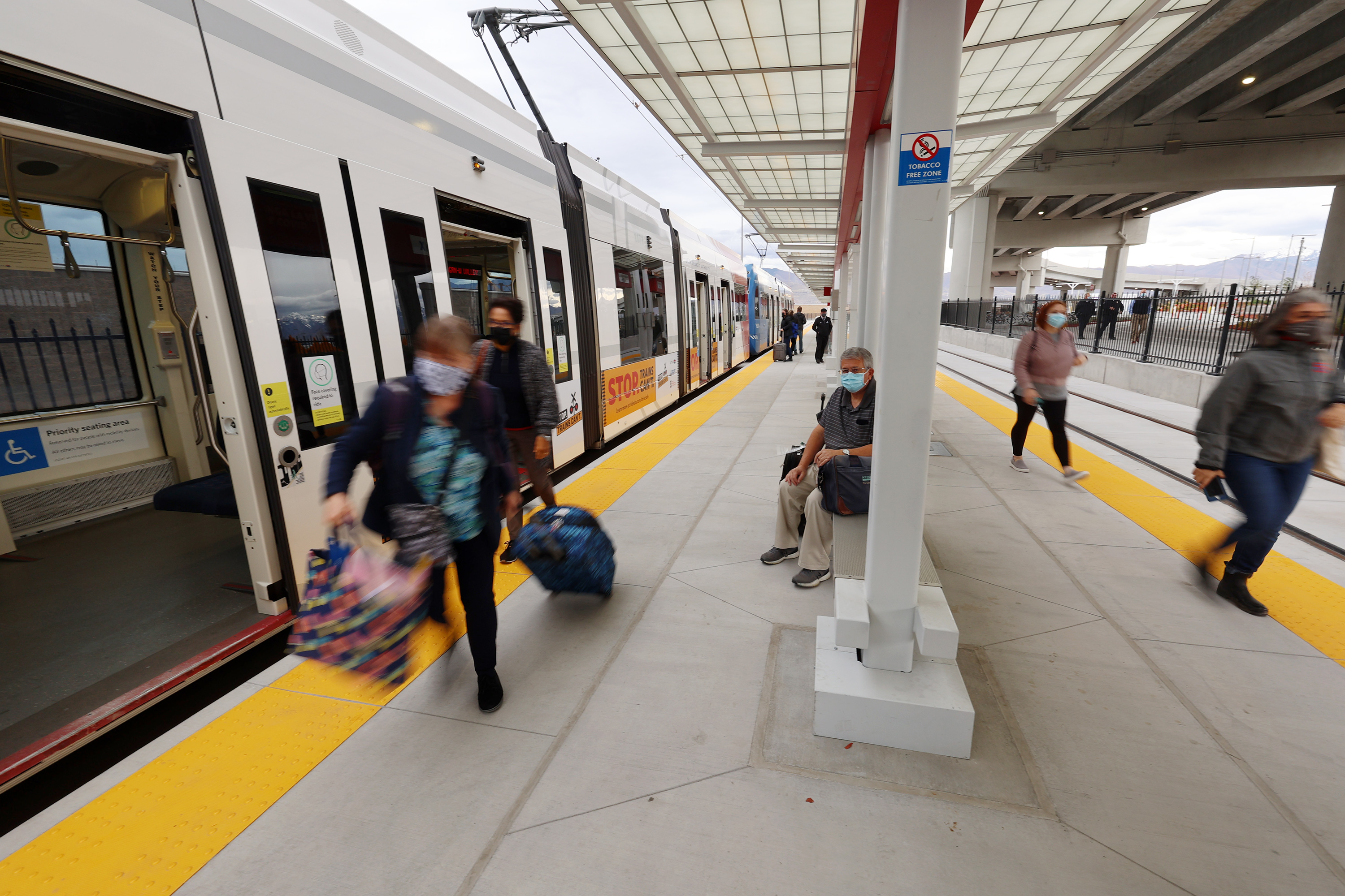 Travelers use the Utah Transit Authority's new TRAX airport station, the culmination of 20 months of construction extending TRAX to the new airport terminal, in Salt Lake City on Oct. 25.