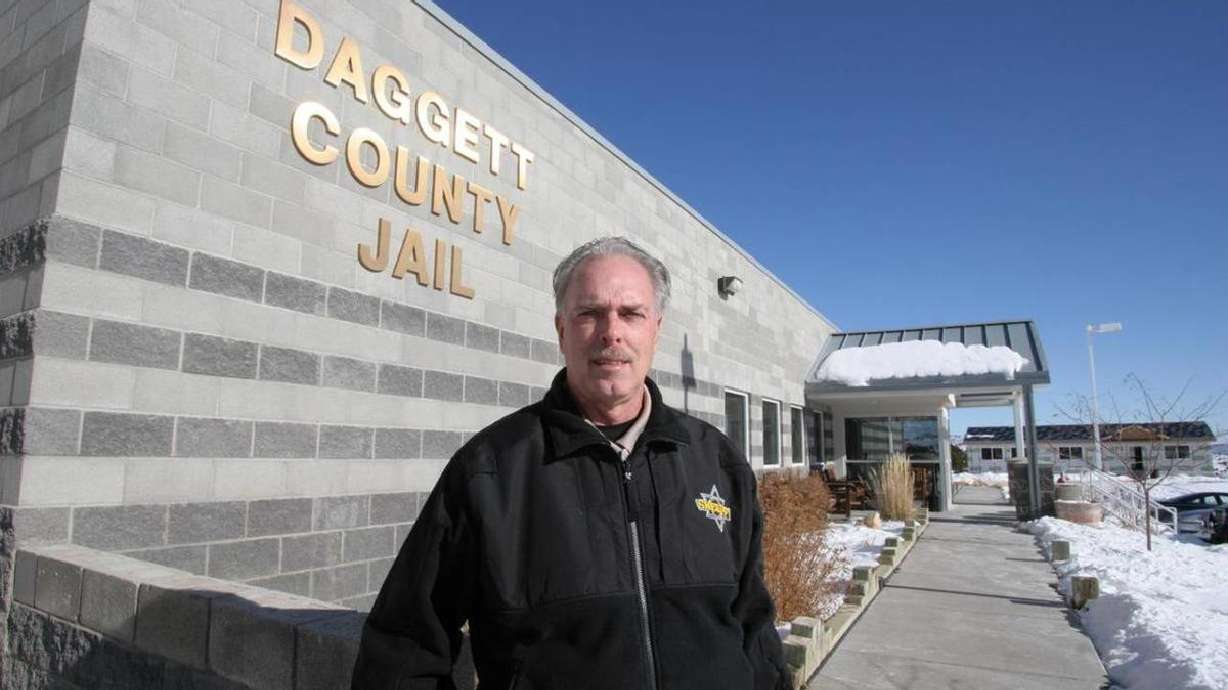 Former Daggett County Sheriff Jerry Jorgensen poses in front of the Daggett County Jail, which has since closed. The American Civil Liberties Union is asking a federal judge to reject a motion from Daggett County to have a lawsuit against it thrown out. The lawsuit alleges that inmates were abused at the jail.