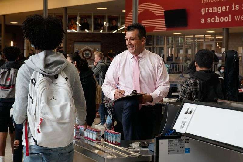 Granger High School principal David Dunn smiles toward
a student as he takes count during lunch break at Granger High
School in West Valley City on Tuesday.
