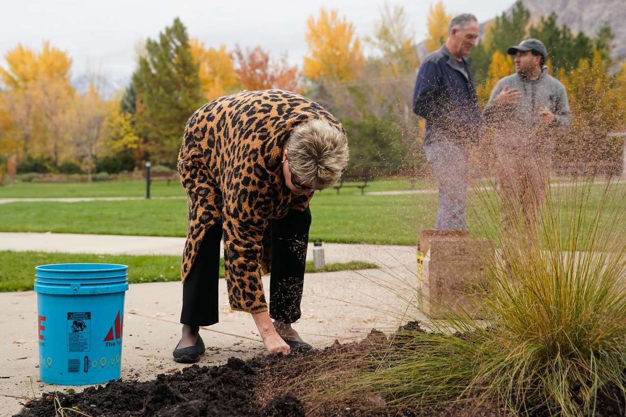 Terri McCulloch from the League of Women Voters plants a daffodil Wednesday during an event honoring the 429 Utahns who lost their lives to gun violence in 2020 hosted by volunteers from the Gun Violence Preventer Center of Utah and the League of Women Voters at Ogden Botanical Gardens.
