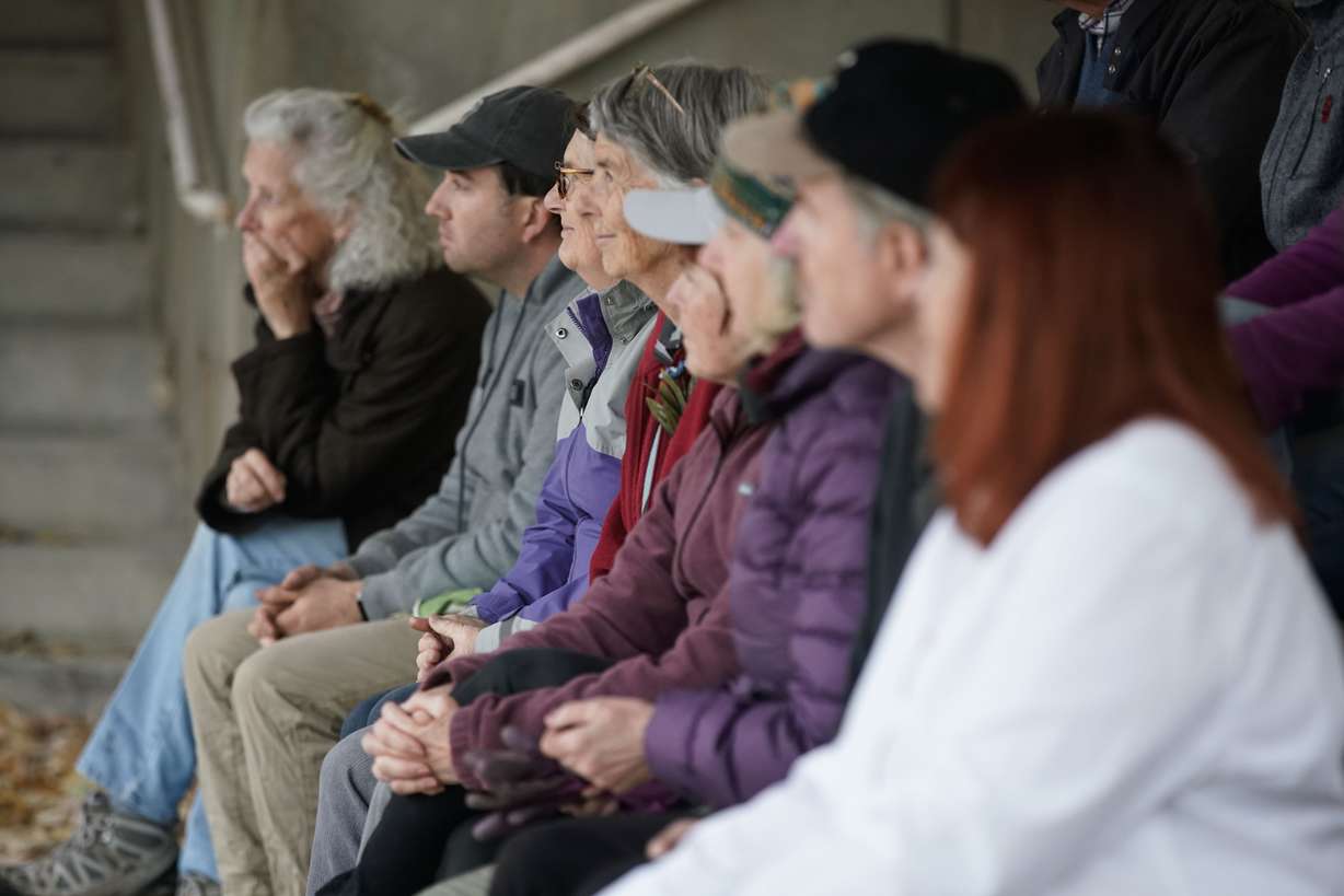 People listen to a speaker during a daffodil-planting event Wednesday honoring the 429 Utahns who lost their lives to gun violence in 2020.