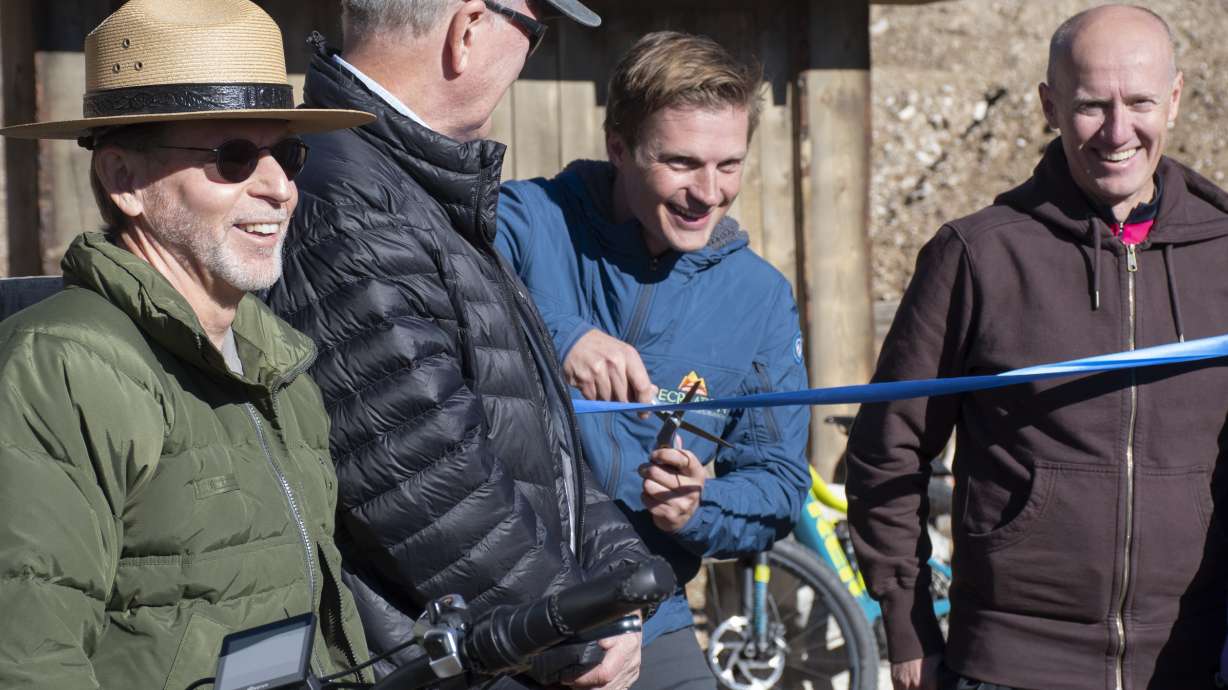 Pitt Grewe, the director of the Utah Office of Outdoor Recreation, cuts a ribbon during a ceremony Wednesday, signaling the opening of the first 10-mile segment of bike trails in Kane County just outside of Zion National Park.