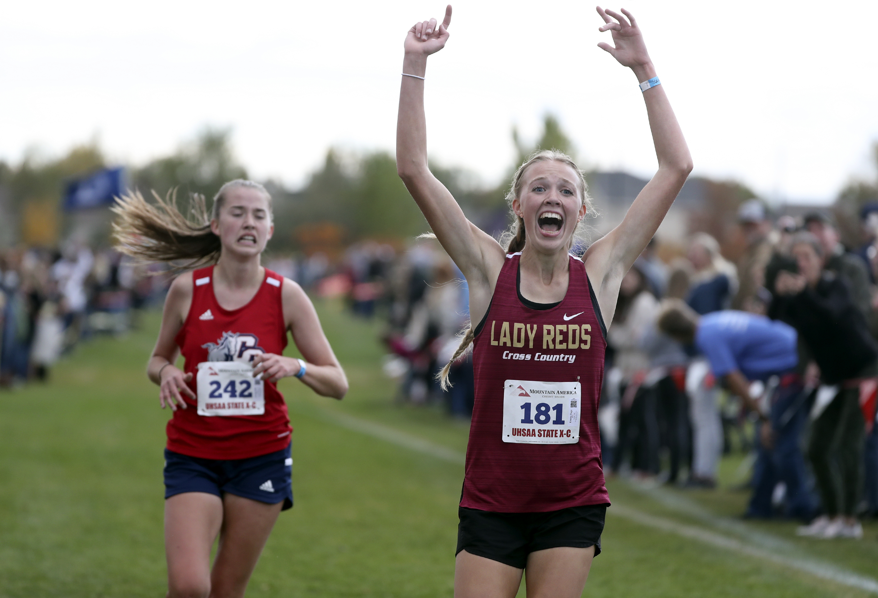 Cedar High School’s Emma Page takes second place as Crimson Cliff’s Sarah Ellis takes third in the 4A cross-country state championship 5K race at the Regional Athletic Complex in Salt Lake City on Wednesday, Oct. 27, 2021.