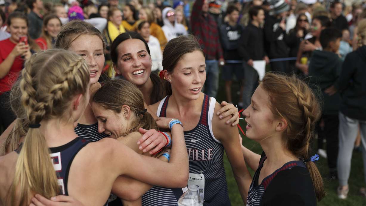 Springville girls celebrate their 5A girls cross-country state championships at the Regional Athletic Complex in Salt Lake City on Wednesday, Oct. 27, 2021.