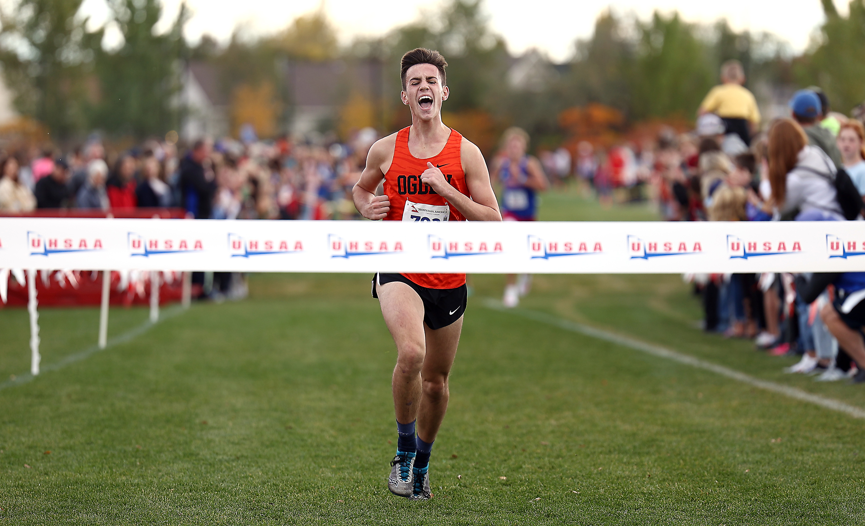 Ogden’s Jack Blodgett, begins his celebration as he nears the tape as runners compete in the cross country state championships at the Regional Athletic Complex in Salt Lake City on Wednesday, Oct. 27, 2021.