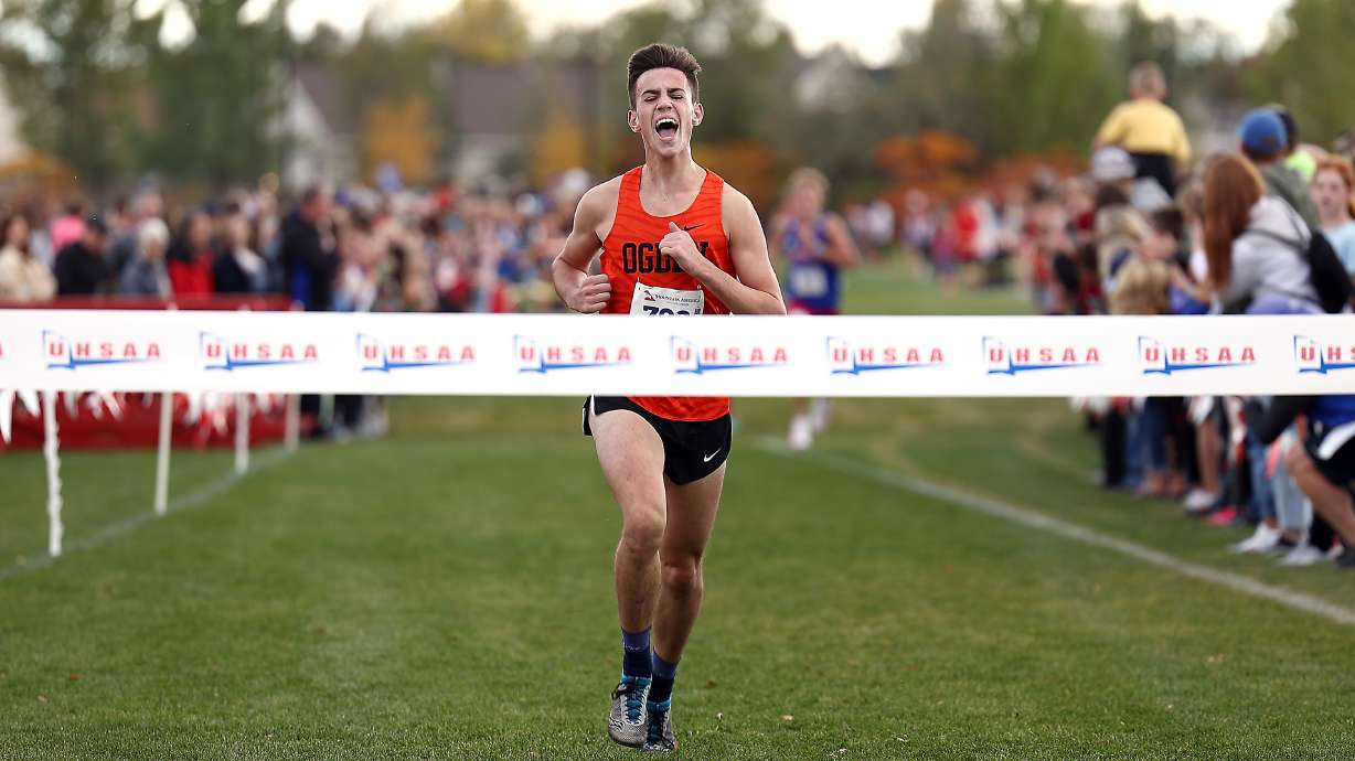 Ogden’s Jack Blodgett, begins his celebration as he nears the tape as runners compete in the cross country state championships at the Regional Athletic Complex in Salt Lake City on Wednesday, Oct. 27, 2021.