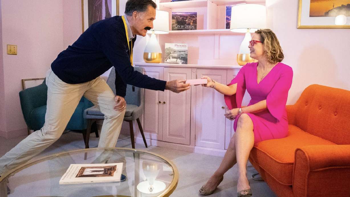 Sen. Mitt Romney, R-Utah, dressed as the Apple TV+ character Ted Lasso, delivers cookies, or biscuits, to Sen. Kyrsten Sinema, D-Ariz. in a photo shared on social media Thursday.