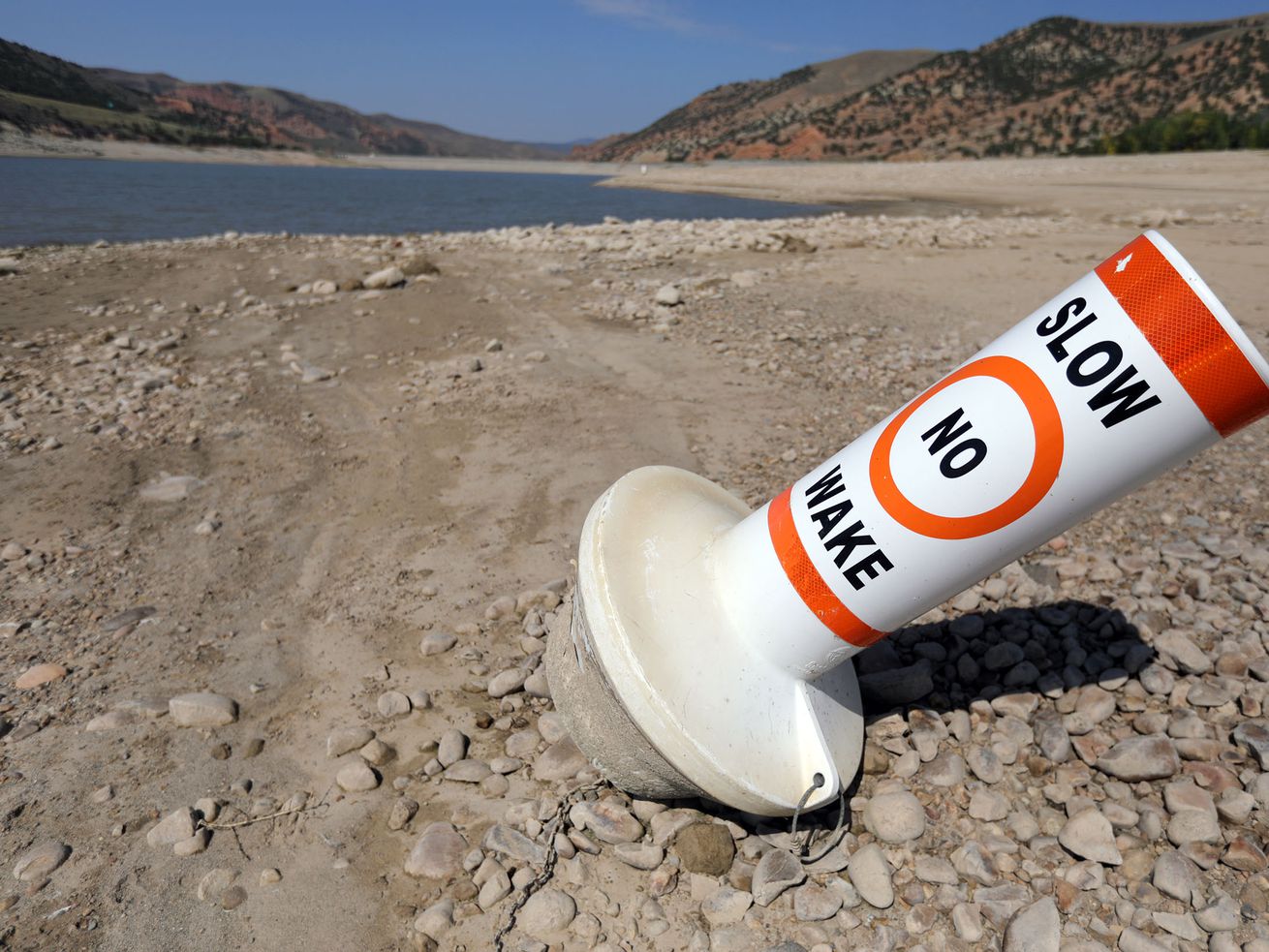 A marker buoy is grounded on the dried-up shore of Echo
Reservoir on Sept. 16. As an estimated 20,000 people descend on Glasgow, Scotland, to discuss climate change and emission tamping goals, the massive United Nations conference, called COP26, will highlight progress, failures and give rise to a call for countries to more aggressively pursue clean energy.