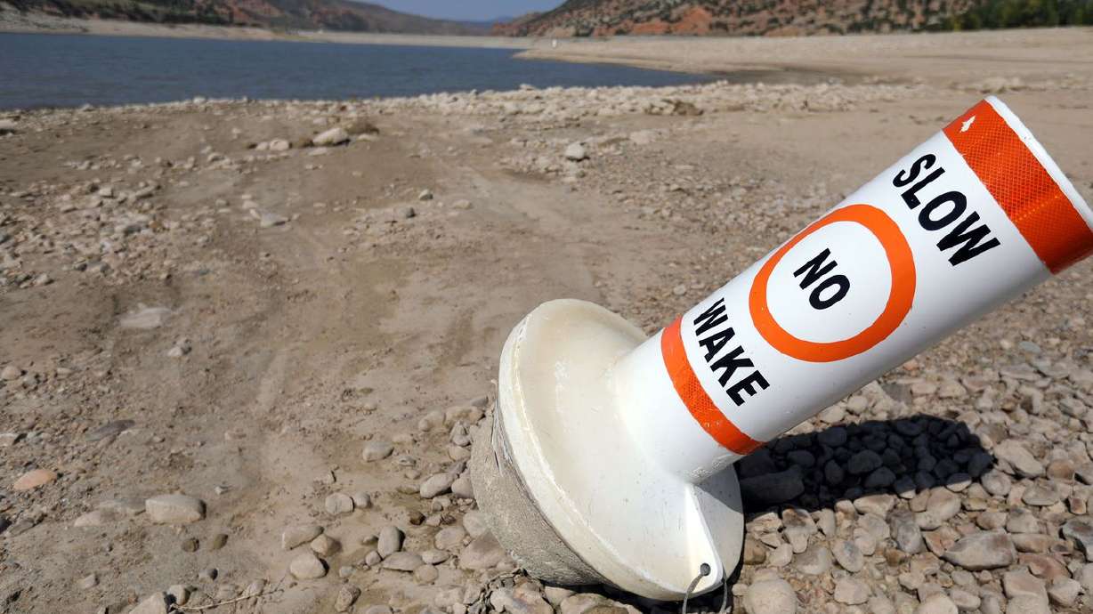A marker buoy is grounded on the dried-up shore of Echo
Reservoir on Sept. 16. As an estimated 20,000 people descend on Glasgow, Scotland, to discuss climate change and emission tamping goals, the massive United Nations conference, called COP26, will highlight progress, failures and give rise to a call for countries to more aggressively pursue clean energy.
