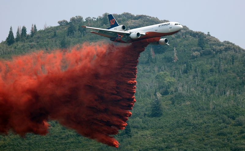 A large tanker drops retardant as crews continue
fighting the Parley’s Canyon Fire near Park City on Aug.
15.