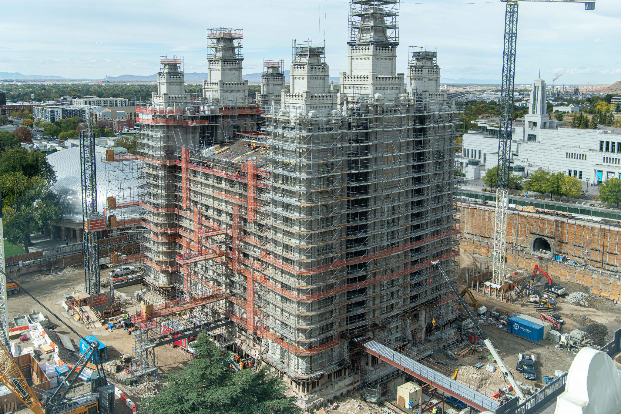 The south and east sides of the Salt Lake Temple are covered by scaffolding and surrounded by construction equipment as crews continue the renovation project started in 2019. The Tabernacle can be seen behind the temple on the left and the Conference Center can be seen in the background on the right, in Salt Lake City in October.