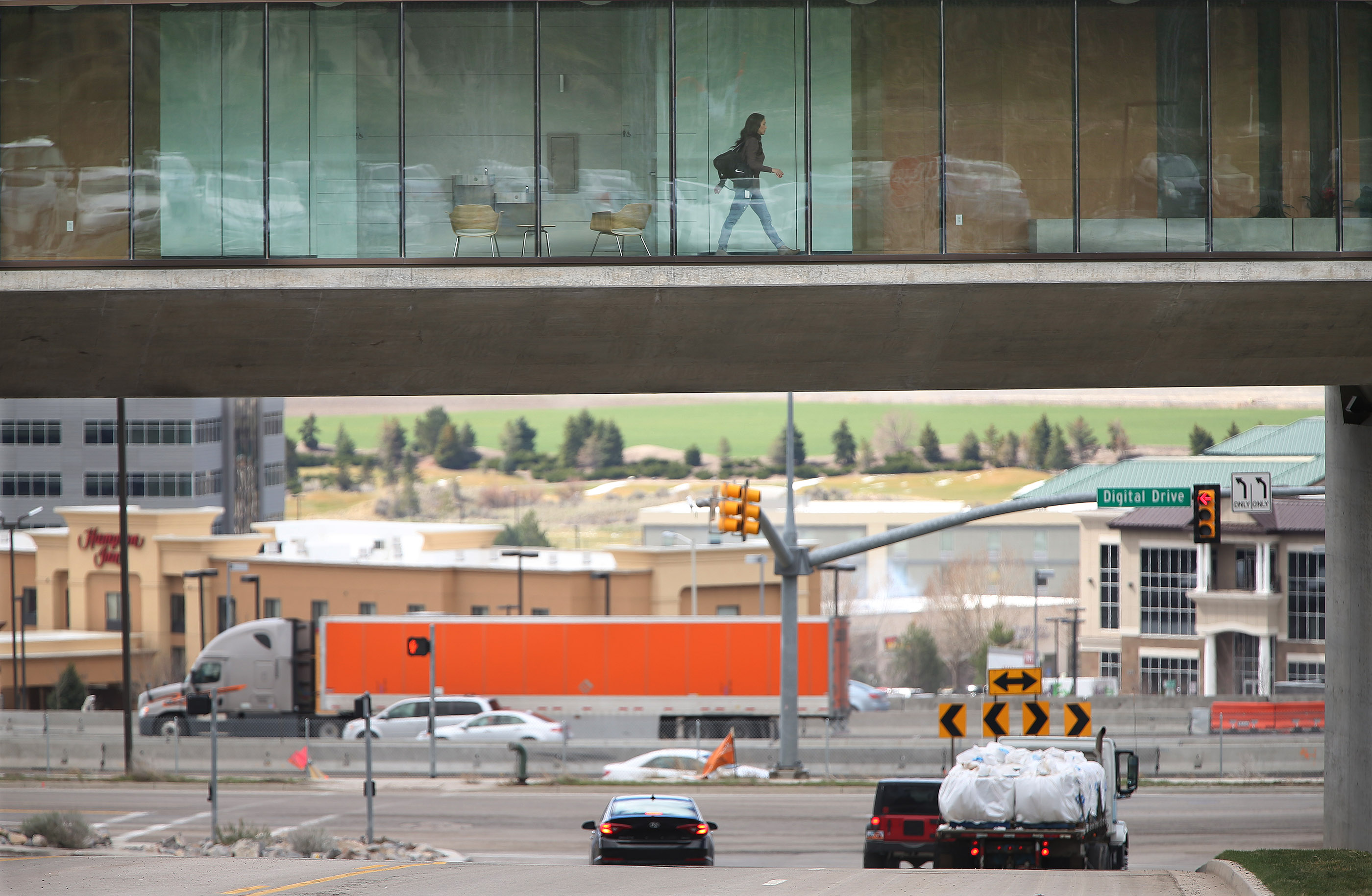 An Adobe employee walks through the office as traffic moves below in Lehi on March 23, 2016. Utah leaders held a summit at Utah Valley University on Thursday to discuss the growth in Utah County and strategies for making sure Utah County continues to be a place people want to come to live and grow their businesses. 