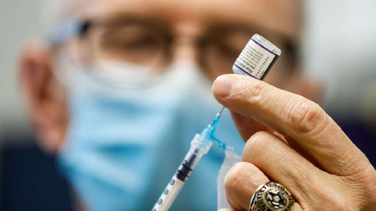 Nurse Jon Hight draws a Pfizer/BioNTech COVID-19 vaccine into a syringe at the Salt Lake Public Health Center on Sept. 30. While businesses in Utah and across the country continue to wait for details and the official implementation of President Joe Biden's private sector vaccine mandate rules announced last month, a new survey shows Utahns are overwhelmingly opposed to the proposed policy.