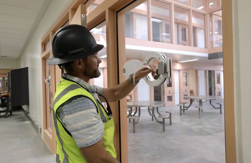 Michael Ambre, assistant director of the state Division
of Facilities Construction and Management, shows a munition port
where tear gas can be administered in the event of a riot at the
new Utah State Prison in Salt Lake City on Thursday, Oct. 21.