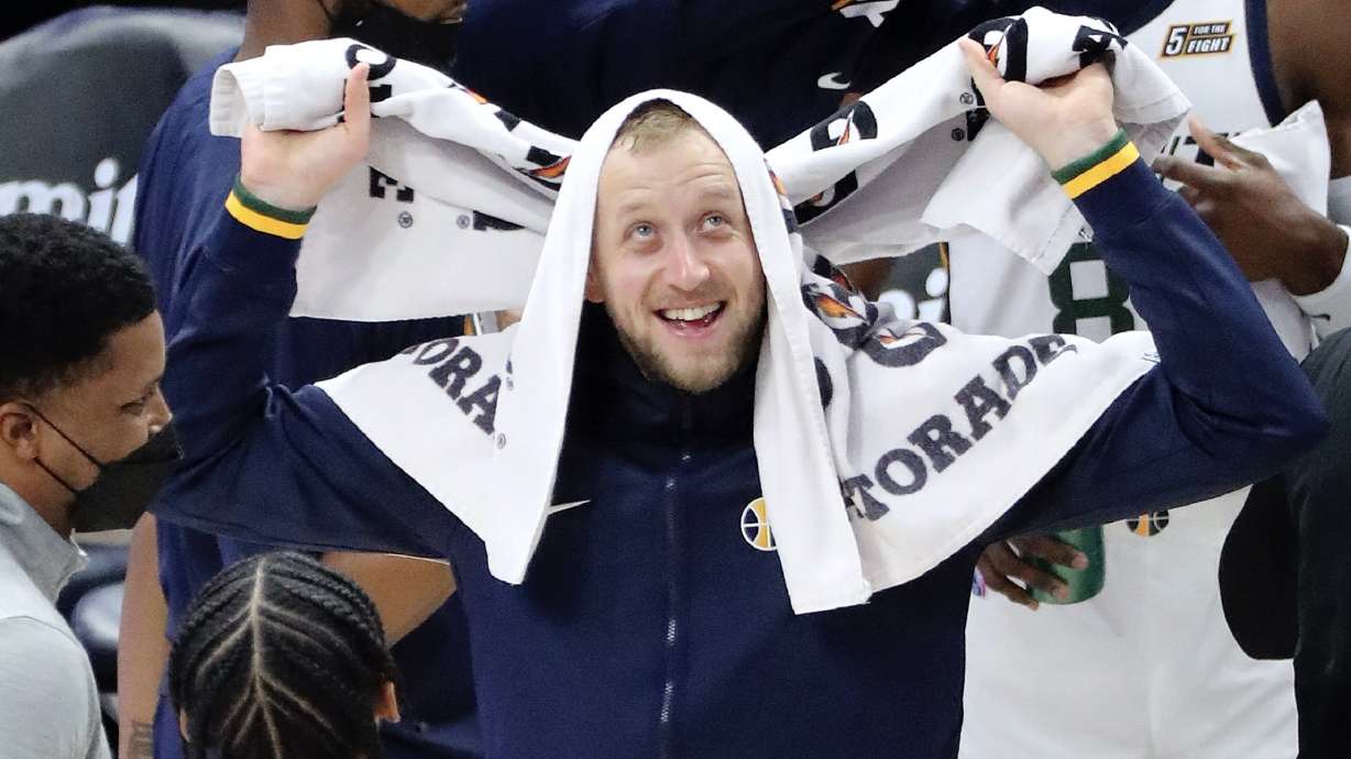 Utah Jazz guard Joe Ingles (2) laughs with his teammates during a timeout in an NBA game.