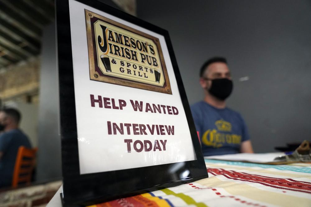A hiring sign is placed at a booth for Jameson's Irish Pub during a job fair in the West Hollywood section of Los Angeles, Sept. 22. New data released Friday by the U.S. Bureau of Labor Statistics shows California is now tied with Nevada for the highest unemployment rate in the country at 7.5%.