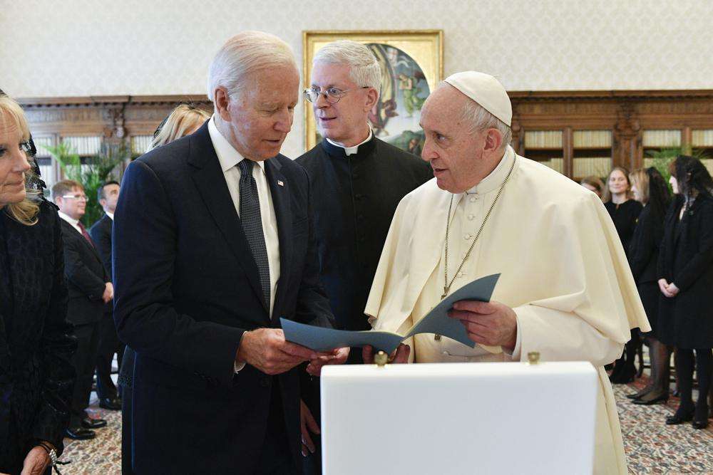 US President Joe Biden, left, exchanges gifts with Pope Francis as they meet at the Vatican, Friday. President Joe Biden is set to meet with Pope Francis on Friday at the Vatican, where the world’s two most notable Roman Catholics plan to discuss the COVID-19 pandemic, climate change and poverty. The president takes pride in his Catholic faith, using it as moral guidepost to shape many of his social and economic policies.