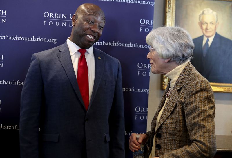 South Carolina Sen. Tim Scott speaks with homeless
advocate Pamela Atkinson at an Orrin G. Hatch Foundation symposium
at Zions Bank Founders Room in Salt Lake City on Friday.