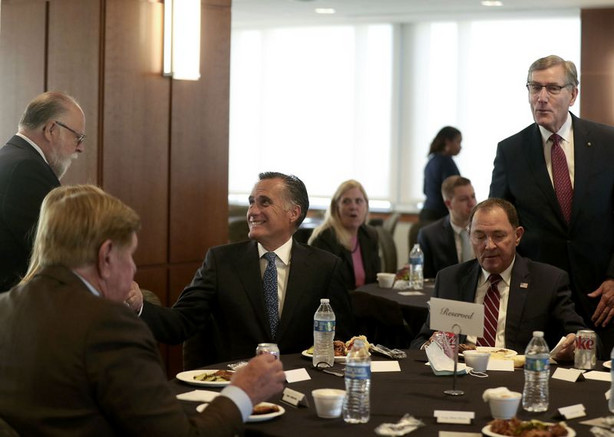 Sen. Mitt Romney, center, former Utah Gov. Gary Herbert
and Scott Anderson, president and chief executive officer of Zions
Bank, standing, attend an Orrin G. Hatch Foundation symposium with
Sen. Tim Scott, R-S.C., at Zions Bank Founders Room in Salt Lake
City on Friday.