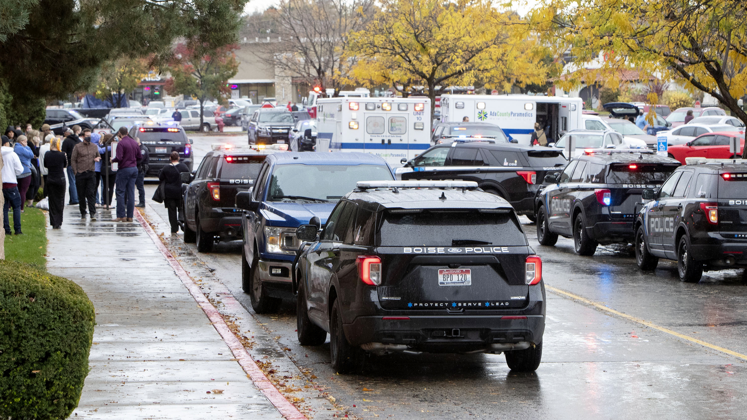 Police and emergency crews respond to a reported shooting at the Boise Towne Square shopping mall Oct. 25 in Boise, Idaho. An Idaho woman was jailed after police say she stole from the body of a security guard killed during the shooting.