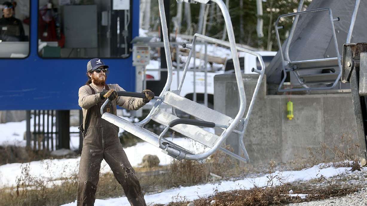 Cody Reed loads chairs onto the Moonbeam Express
chairlift in preparation for the upcoming ski season at Solitude
Mountain Resort in Salt Lake City on Thursday.