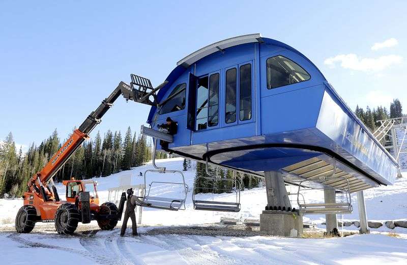 Cody Reed and Pekka Vanninen load chairs onto the
Moonbeam Express chairlift in preparation for the upcoming ski
season at Solitude Mountain Resort in Salt Lake City on Thursday.