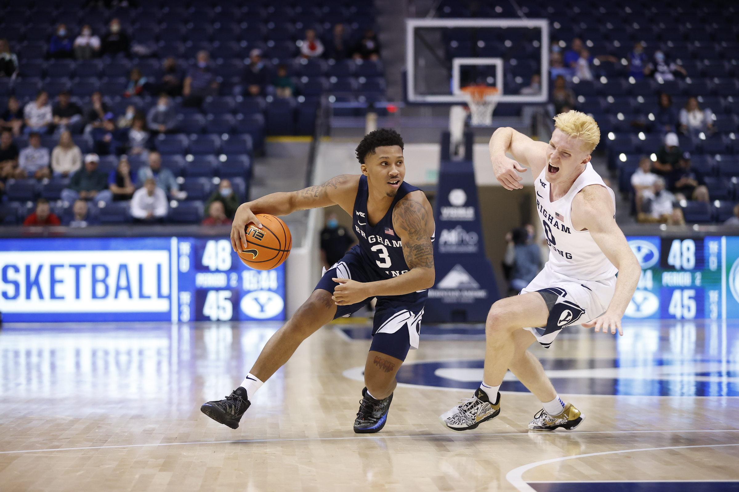 BYU guard Te'Jon Lucas drives around guard Hunter Erickson during the Cougars' annual Blue-White game, Friday, Oct. 29, 2021 in Provo.