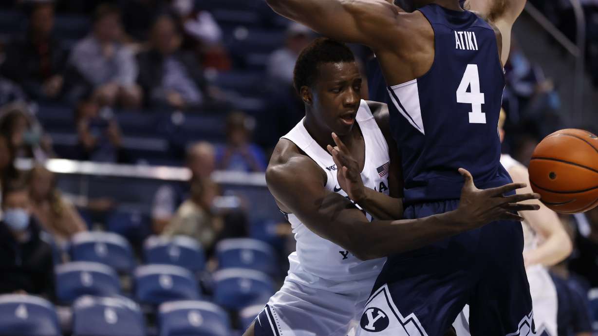 BYU forward Fousseyni Traore passes around Atiki Ally Atiki during the Cougars' annual Blue-White game, Friday, Oct. 29, 2021 in Provo.