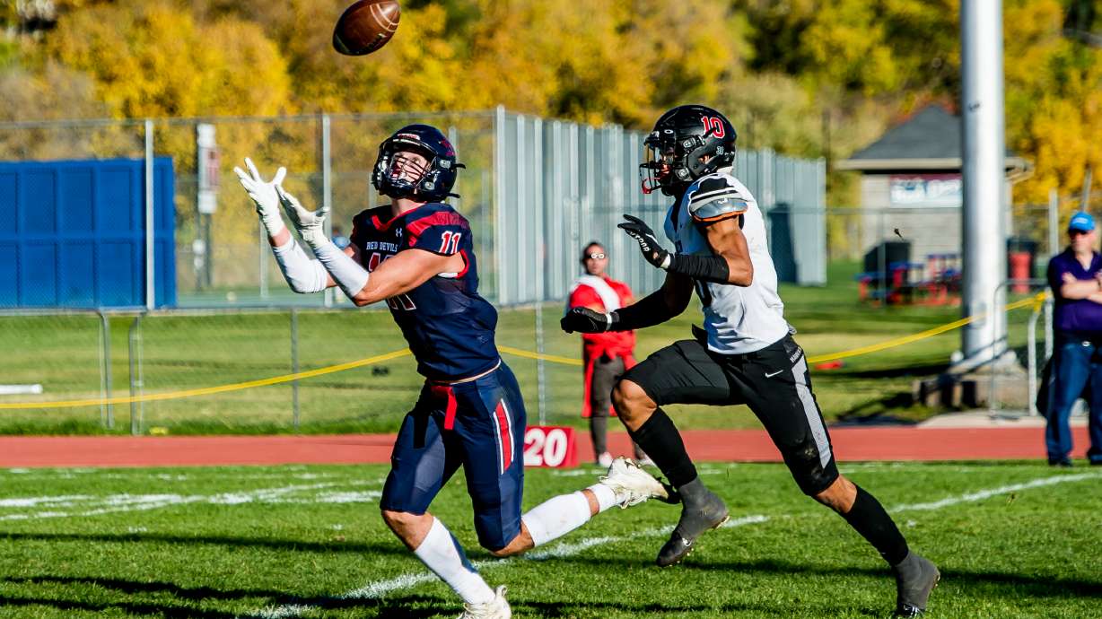 Springville wide receiver Cole Clement hauls in a pass from Ryder Burton during the Red Devils' 5A second-round playoff game against Alta, Friday, Oct. 29, 2021 in Springville.
