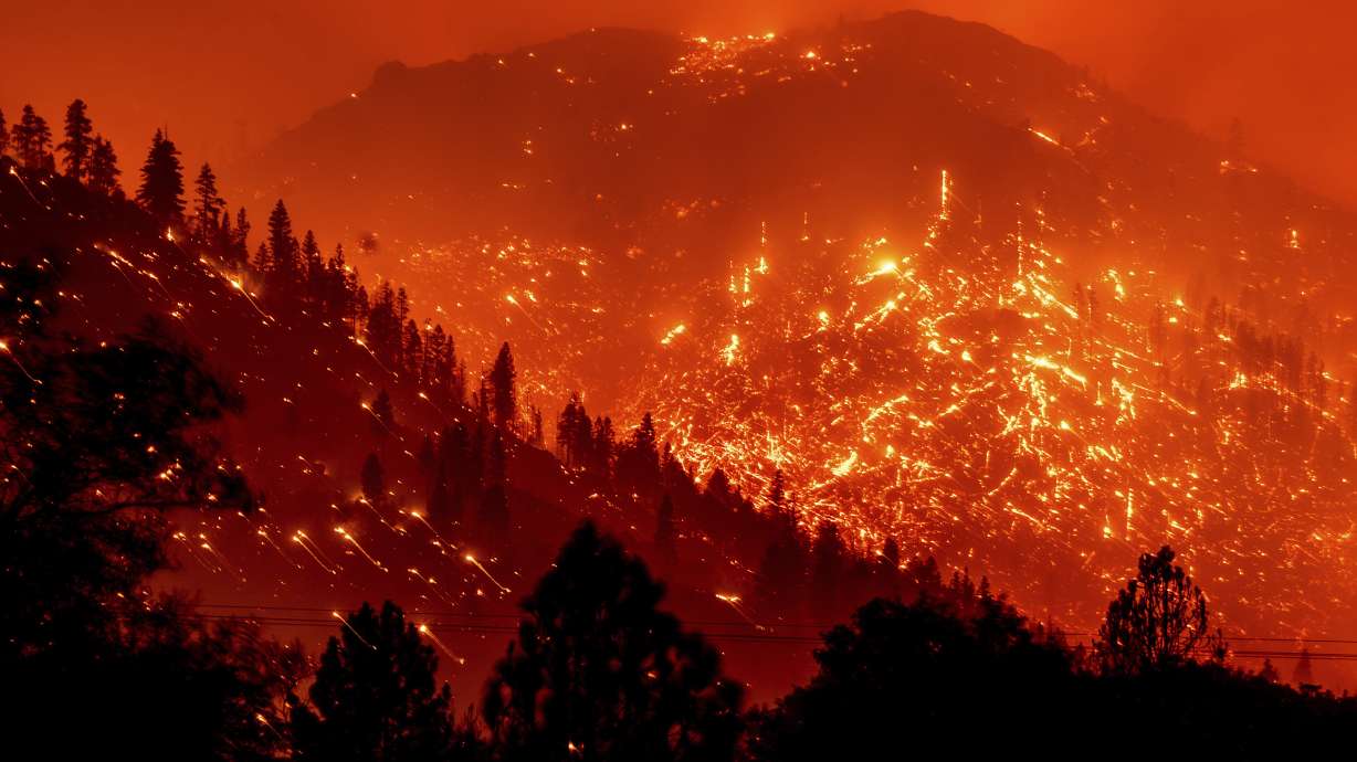 Embers light up hillsides as the Dixie Fire burns near Milford in Lassen County, Calif. World leaders have been trying to do something about climate change for 29 years but in that time Earth has gotten much hotter and more dangerous.