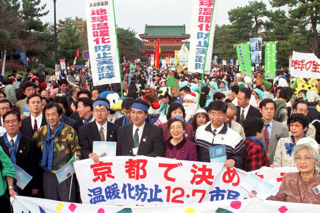 Environmentalists and citizens hold banners calling for reduction of green house gas emissions in front of the Heian shrine in Kyoto, western Japan in 1977. In Kyoto, a protocol set carbon pollution cuts for developed countries but not poorer nations. That did not go into effect until 2005 because of ratification requirements.