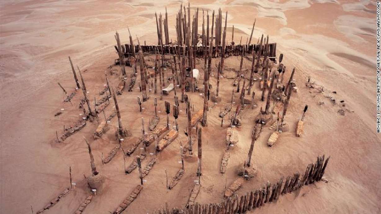 The ancestry of hundreds of mummified bodies buried in boats in an inhospitable desert region of northwest China has puzzled and divided archaeologists.