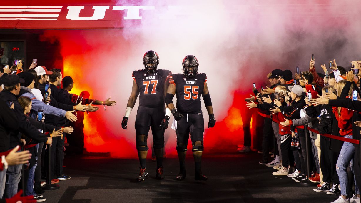 Utah Utes offensive lineman Bamidele Olaseni (77) and Utah Utes offensive lineman Nick Ford (55) lead the team walk out before the game at Rice Eccles Stadium in Salt Lake City, Utah on Saturday, Oct. 30, 2021.