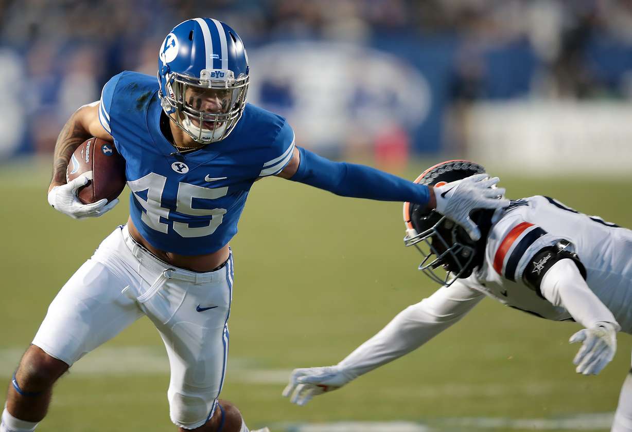 BYU wide receiver Samson Nacua (45) pushes Virginia cornerback Darrius Bratton (8) aside after a catch as BYU and Virginia prepare to play at LaVell Edwards stadium in Provo on Saturday, Oct. 30, 2021.