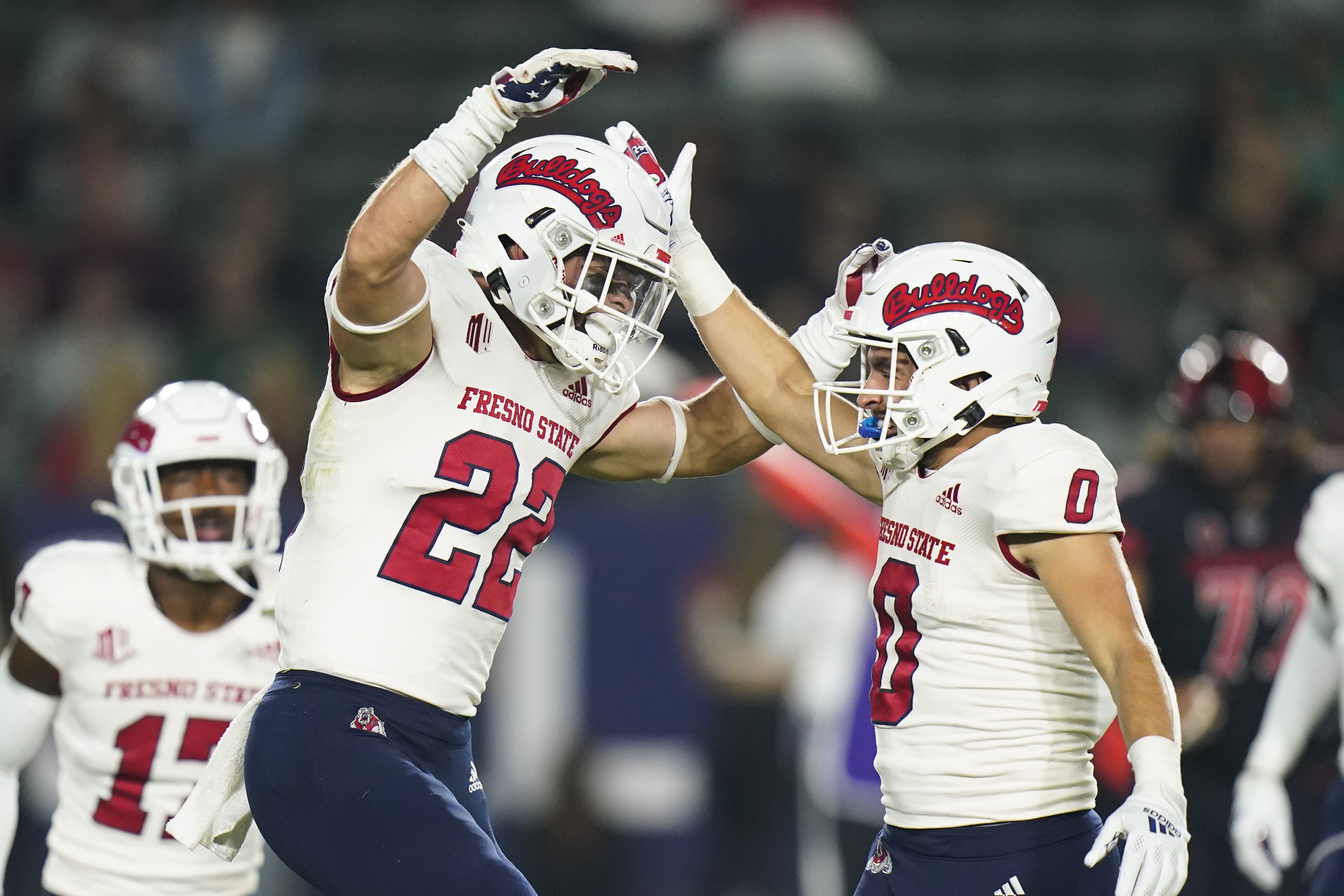Fresno State defensive back Steven Comstock, left, celebrates his tackle with Mac Dalena during the first half of the team's NCAA college football game against Fresno State on Saturday, Oct. 30, 2021, in Carson, Calif.